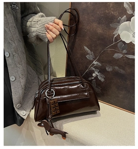 Deep brown patent leather shoulder bag with chocolate and dachshund pendants