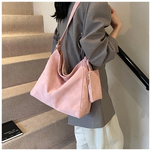 Detail of pink vintage tote bag with matching coin purse on minimalist staircase