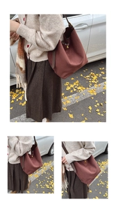 Detail of suede tote bag showing large capacity and golden turn-lock closure in autumn setting