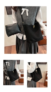 Detailed view of black faux suede tote bag set with golden metal buckle and small pouch