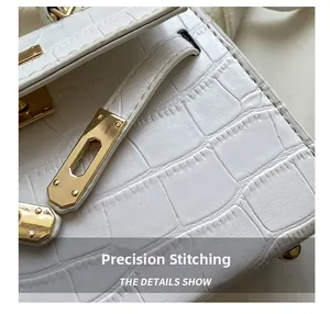Detail showing white crocodile embossed leather texture and computerized stitching