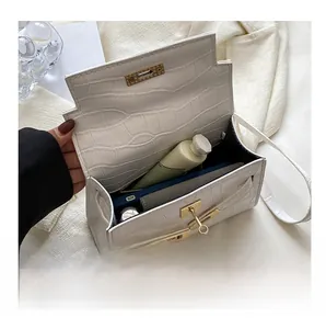 Interior view of white crocodile pattern handbag showing space for wallet and phone