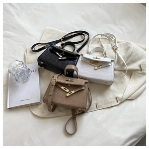 Three elegant crocodile-patterned crossbody handbags in black, white, and khaki colors