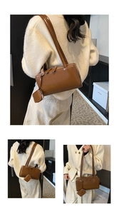 Close-up of a vintage brown glossy leather tote bag with a matching mini coin purse detail