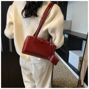 Detail view of smooth red leather tote bag with a matching mini zip coin pouch