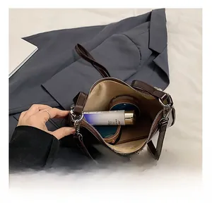 Detailed interior view of a brown leather bag showing large capacity and smooth zipper