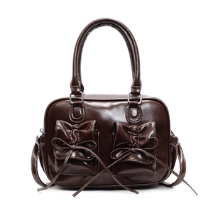 Deep brown oil wax leather handbag with bow accents and contrast stitching details