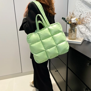 Quilted lime green puffer tote bag with padded texture and adjustable shoulder strap