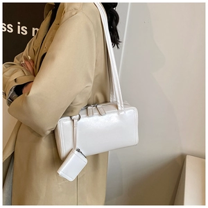 Detail view of white polished PU leather tote bag with silver hardware and mini coin purse