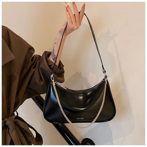 Detail of black semi-moon underarm bag with silver chain and NO FILTER text