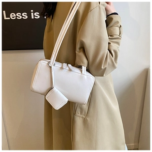 Minimalist white leather rectangular shoulder bag with detachable mini earphone pouch detail