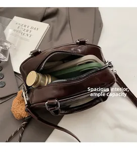 Detail view of large interior capacity for vintage brown leather bag with accessories