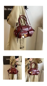 Detail of deep red Boston bag featuring multi-pocket design and retro shiny PU leather