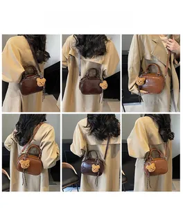 Retro mini Boston bag shown in various carrying styles with plush bear charm