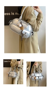 Detail view of silver bowling bag with multiple zippers and baseball glove charm