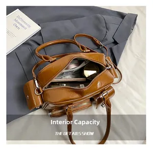 Macro view of brown leather tote bag interior showing large capacity and multi-pockets