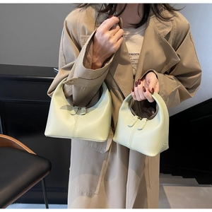 Detail of mint green crescent handbags with leather pullers and double zipper closure