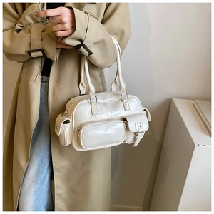 Chic cream white PU leather bowling bag styled on model wearing a classic khaki trench coat