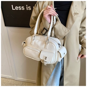 Detail of white vintage bowling bag with multi-pocket design and matte leather finish