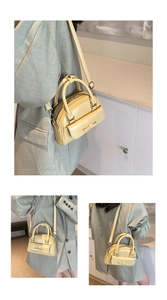 Detail of light yellow mini handbag with decorative bow and smooth leather finish