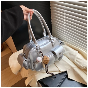 Detail of silver metallic PU bowling bag with multi-pocket design and baseball charm
