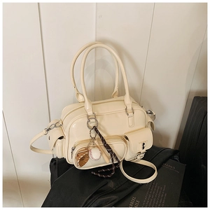 Detail of off-white faux leather bowling bag with multi-pockets and baseball keychain charm
