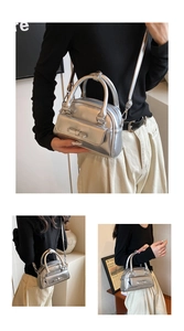 Detail of silver mirror Boston bag with bow accent and versatile carrying straps