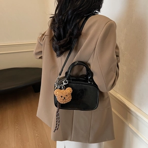 Retro black patent leather baseball shoulder bag with plush bear charm and glossy finish