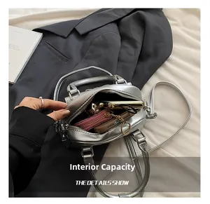Top view of metallic silver Boston bag interior showing spacious capacity for phone and wallet