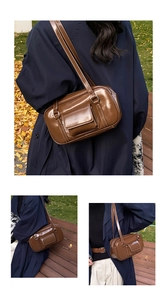 Detail of vintage brown PU leather shoulder bag with white contrast stitching and pockets