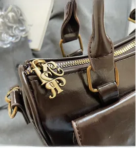 Detailed close-up of smooth zipper with antique bronze metal hardware on retro handbag