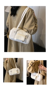 Detailed close-up of a white rectangular leather shoulder bag with functional front pocket