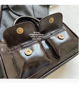 Detail of dark brown vintage faux leather bag showing powerful magnetic snap closures