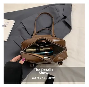 Internal capacity of the brown retro leather handbag showing cosmetic storage space