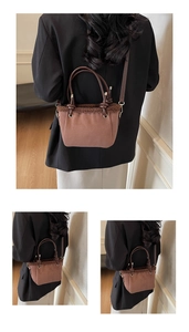 Detail of vintage brown suede bucket bag with faux fur trim and gold hardware