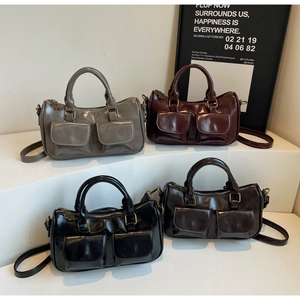 Macro display of four vintage leather crossbody bags in grey, wine, black, and dark brown