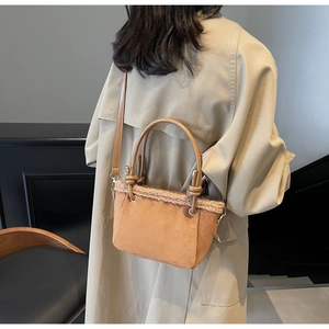 Detail of caramel matte crossbody bag with faux fur trim and gold hardware