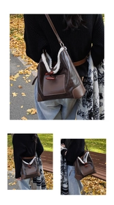 Detailed view of the wooden toggle closure and plush faux fur trim on the brown suede bag