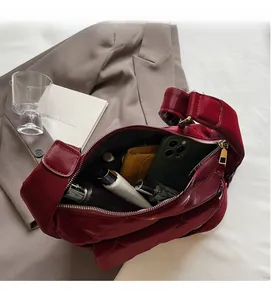 Top view of open burgundy quilted bag showing large capacity for daily essentials