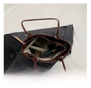 Spacious interior of brown leather tote bag showing organized main compartment and pockets