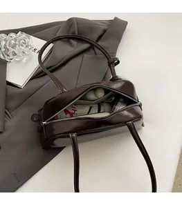 Close-up of dark brown leather tote interior showing spacious storage for daily items