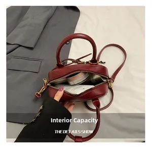 Interior view of the burgundy crossbody bag showing capacity for daily cosmetics