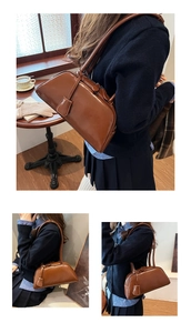 Detail view of caramel brown vintage leather boston bag with slim straps in a cozy cafe