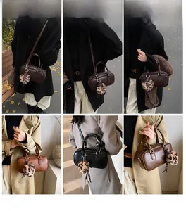 Detailed views of multi-color Boston bags with leopard heart charms and shoulder straps