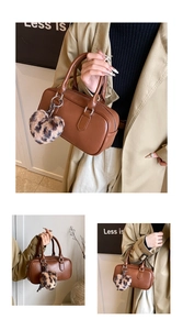 Detail view of brown PU leather bowling bag with leopard print plush heart charm