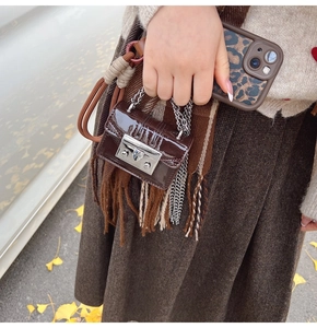 Mini brown patent leather crossbody bag with silver lock and chain for autumn outfits