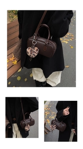 Detail of retro dark brown bowling bag with leopard print heart plush keychain