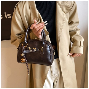 Détail du sac Boston marron foncé rétro avec cloches dorées et ferrures