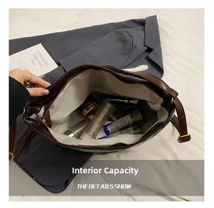 Interior view of large brown leather tote bag showing spacious storage with fabric lining