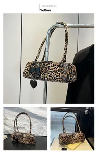 Detailed shot of leopard print Boston bag featuring a black bow and heart pendant charm
